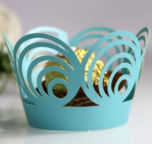 Macro detail of laser-cut Tiffany blue pearlescent paper cupcake liner with hollow pattern