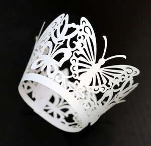 Detailed laser-cut white cupcake wrapper with elegant butterfly and floral lace design