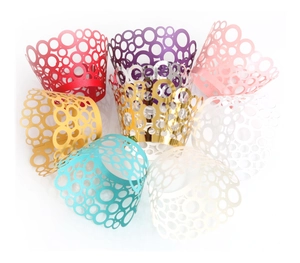 Laser-cut cupcake wrappers with round hole patterns in multiple metallic colors