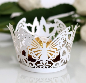 Elegant white laser-cut butterfly cupcake wrappers for wedding table decorations