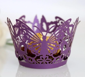 Close-up of laser-cut purple butterfly cupcake wrapper with pearlized finish for weddings