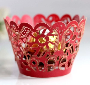Red laser-cut floral cupcake wrapper with intricate patterns for wedding decor