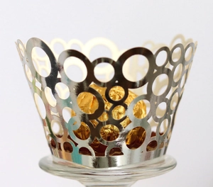 Champagne gold laser-cut cupcake wrappers with layered circular hollow design for parties