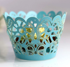 Intricate laser-cut lake blue cupcake wrappers featuring elegant hollow-out floral patterns