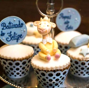 Detail of blue laser-cut lace cupcake wrapper with custom topper for party events