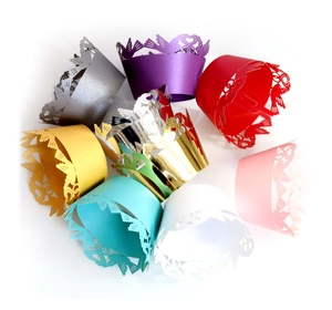 Intricate laser-cut heart and feather pattern cupcake wrappers in multiple colors
