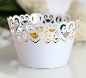 Laser cut heart cupcake wrapper in pearlescent white paper with golden chocolate inside