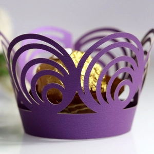 Deep purple laser-cut cupcake wrappers with elegant spiral patterns for wedding decorations