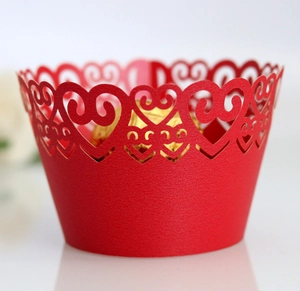 Detail showing laser-cut red heart lace pattern on a high-quality paper cupcake wrapper