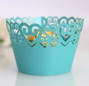 Detail of Tiffany blue cupcake wrapper featuring laser-cut heart pattern and glitter texture
