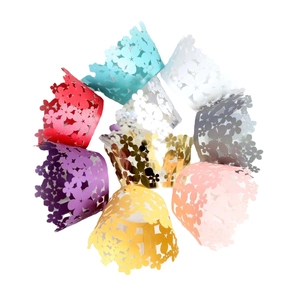 Laser cut floral cupcake wrappers in various colors with scalloped edges for party decor