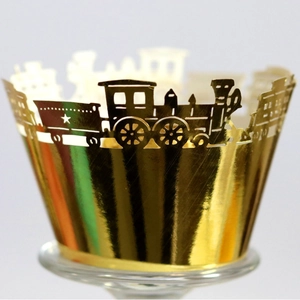 Golden laser-cut cupcake wrappers with vintage train patterns and star cutouts
