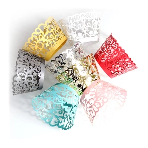 Laser cut hollow cupcake liners with floral patterns in multiple metallic colors