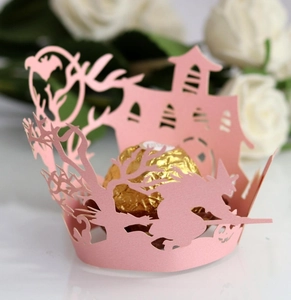 Pink laser-cut Halloween cupcake wrapper with witch, castle and bat silhouettes