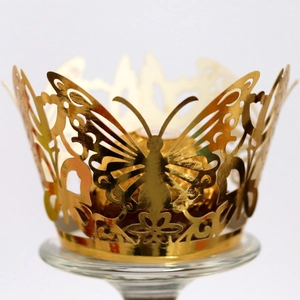 Golden laser-cut butterfly cupcake wrappers for festive party dessert decorations