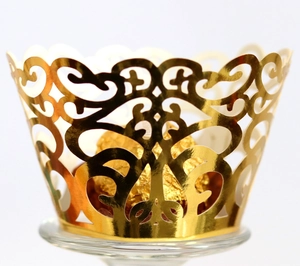 Detailed laser-cut gold cupcake wrapper with elegant vine pattern and metallic finish