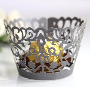 Detailed laser-cut silver cupcake wrapper with elegant vine pattern for party decoration