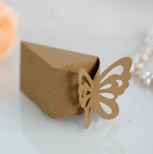 Macro shot of brown kraft paper candy box with laser-cut butterfly and floral decor