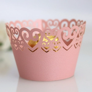 Pink laser-cut cupcake wrapper with heart patterns for wedding cake decoration