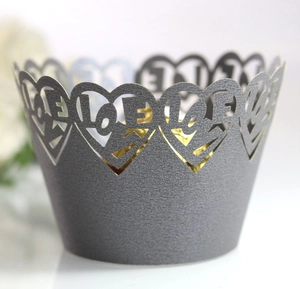 Detailed laser-cut silver cupcake wrapper with heart pattern and LOVE lettering