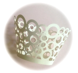Laser-cut pearl white lace cupcake wrappers with elegant circular hollow patterns