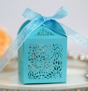 Detailed laser-cut hollow sunflower pattern on a light blue gift box with ribbon