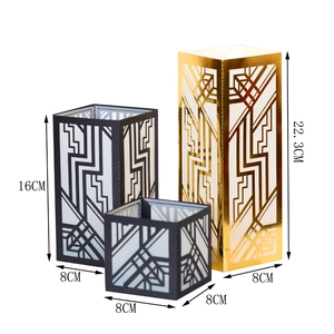 Detailed view of laser-cut geometric candle covers in gold and black with dimensions