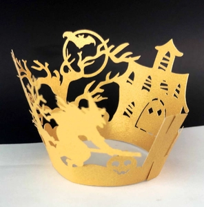 Golden laser-cut Halloween cupcake wrapper featuring witch and haunted castle designs
