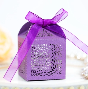 Detailed close-up of lavender laser-cut gift box with floral patterns and a silk ribbon
