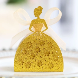 Detail of laser-cut princess dress candy box with gold glitter finish and silk bow