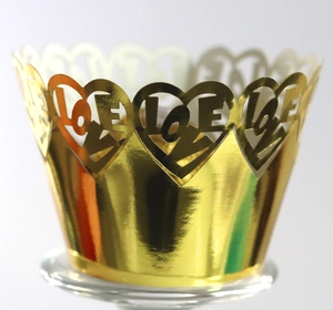 Close-up of golden mirror finish cupcake wrapper with hollowed heart and LOVE design