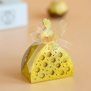 Detail of laser-cut princess silhouette candy box with gold glitter finish and satin bow