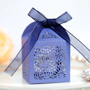 Close-up of laser-cut purple gift box with delicate floral patterns and blue ribbon bow