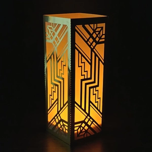 Art Deco gold laser-cut paper lampshade with warm glow and geometric hollow patterns
