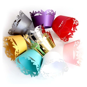 Laser-cut cupcake liners in various pearlized colors with bird and heart patterns