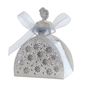 Detail of silver glitter laser-cut gift box featuring girl silhouette and blue ribbon