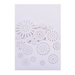 Close-up of laser cut floral patterns and firework details on a white wedding invitation