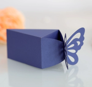 Detail of dark blue laser-cut candy box with delicate hollow butterfly wing pattern