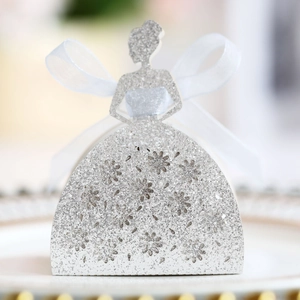 Detail of silver glitter wedding candy box with laser-cut lace floral pattern and bow