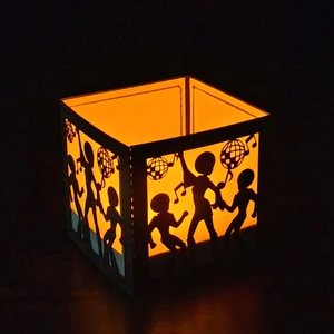 Laser-cut disco party paper lantern featuring dancer silhouettes and warm orange light glow