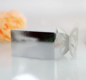 Macro view of silver butterfly cutout wedding candy box with shiny metallic foil finish