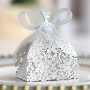 Detail of silver glitter laser-cut candy box in princess gown shape with blue ribbon