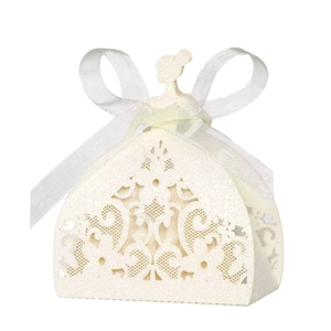 Macro shot of laser-cut bridal gown candy box with white lace texture and ribbon