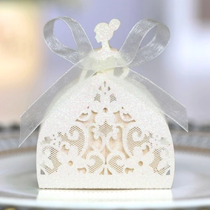 Detailed laser-cut white glitter candy box shaped like a dress with a satin bow