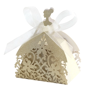 Detail of laser-cut gold glitter wedding candy box in princess dress shape with silk bow