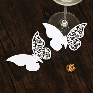 Detailed laser-cut white butterfly paper card for wine glass wedding decor