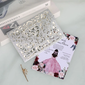 Macro detail of laser-cut silver glitter invitation with XV Años pink floral illustration