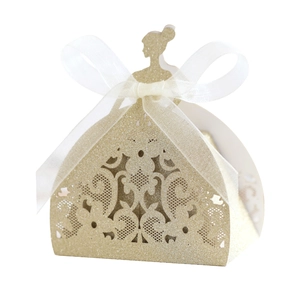 Close-up of golden laser-cut gown candy box with glitter finish and chiffon bow