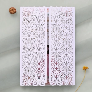 Détail de l'invitation de mariage découpée au laser avec motifs de vignes et fleurs complexes