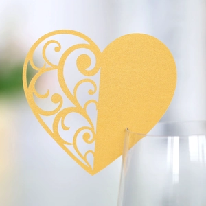 Golden heart-shaped laser cut wine glass place card with pearl finish for weddings
